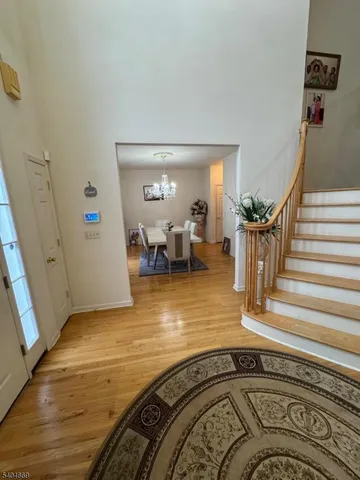 a view of a livingroom with wooden floor and a fireplace