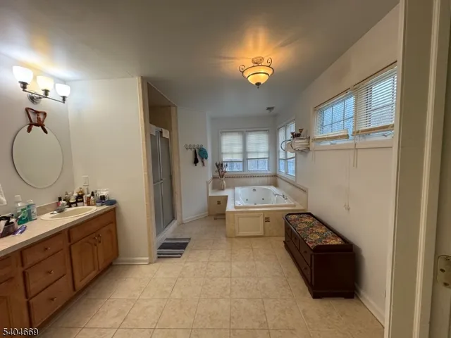 a room with a couch and a stove next to a window