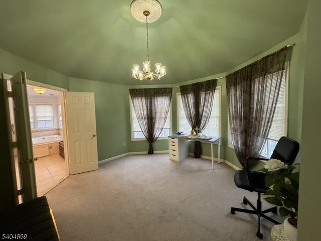 a view of a livingroom with a furniture window and outside view