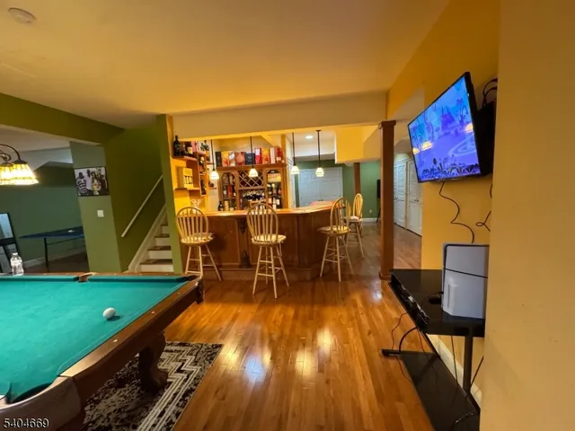 a dining room with furniture and a kitchen view