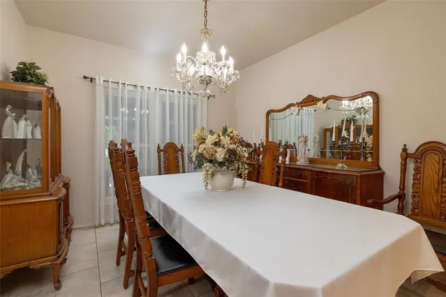 a dining room with furniture and chandelier