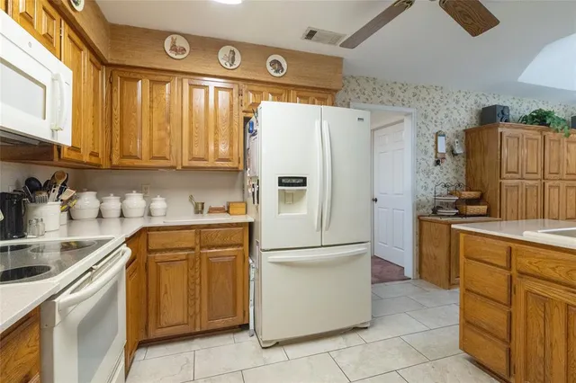 a kitchen with appliances cabinets and furniture