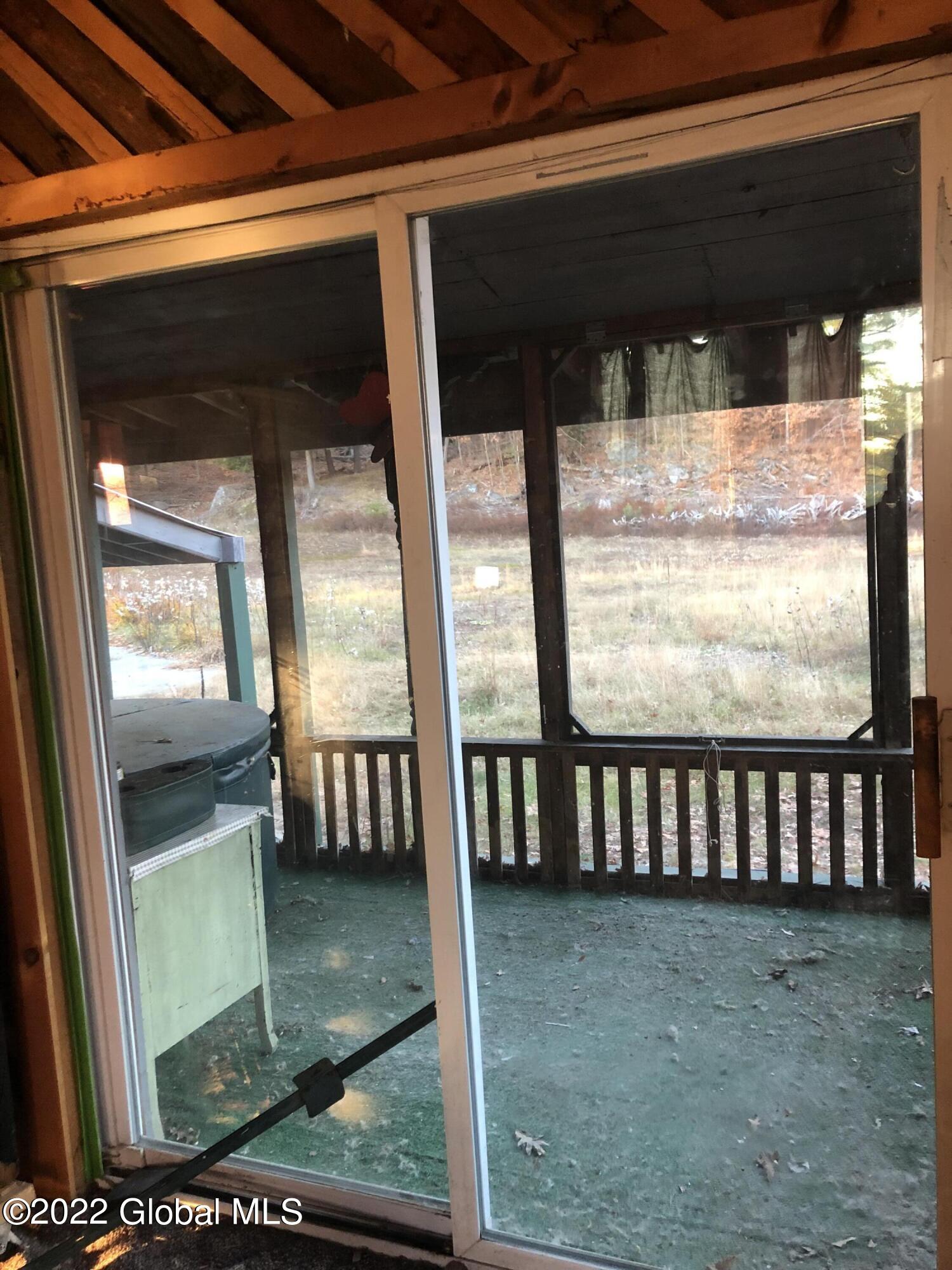 40 Cameron Road Thurman, NY 12810 - Photo 19 of 48 Screened porch off Living Room