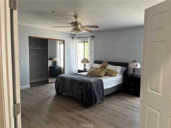 a view of a hallway with couches and dining table