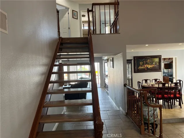 a bedroom with a large bed and a flat tv screen on dresser