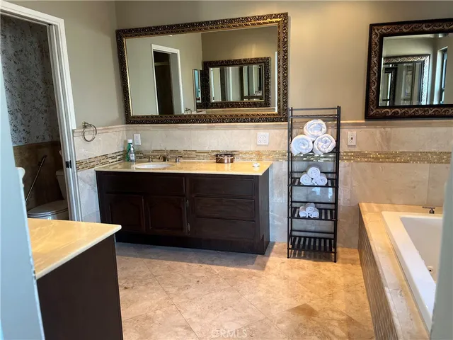 a bathroom with a sink a toilet and bathtub