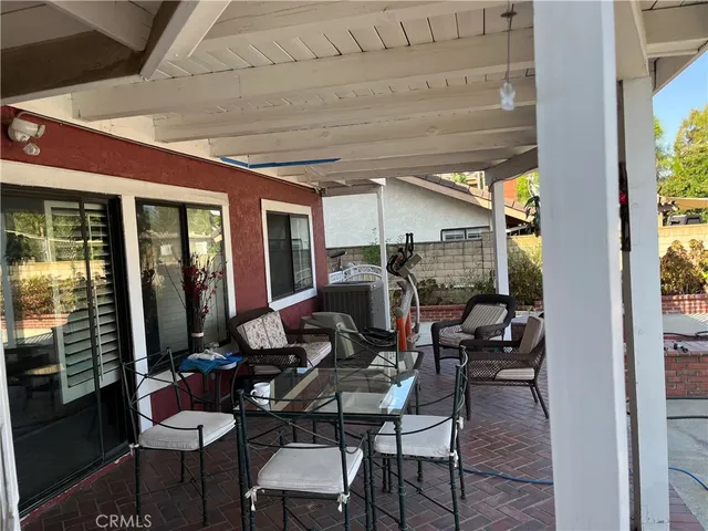 a living room with furniture a fireplace and a potted plant