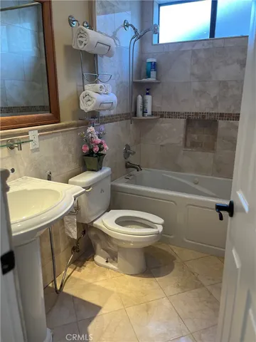 a dining room with furniture a chandelier and window