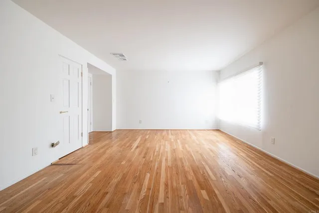 an empty room with wooden floor