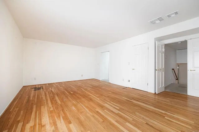 a view of a room with wooden floor and a sink