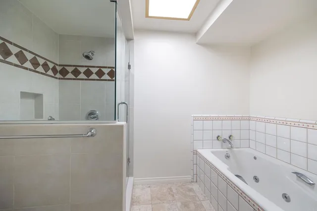 a bathroom with a bathtub and shower