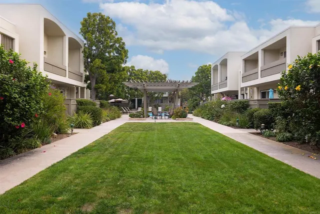 a view of yard in front of house with outdoor seating