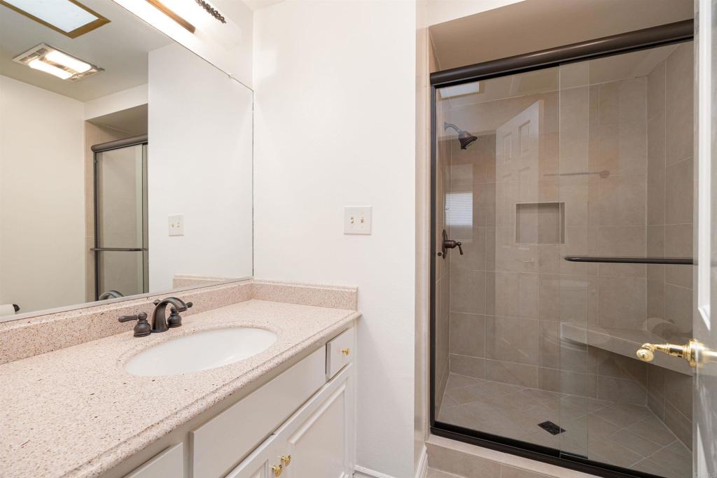 13236 Fiji Way, Unit L Marina del Rey, CA 90292 - Photo 10 of 20 a bathroom with a granite countertop sink mirror and shower