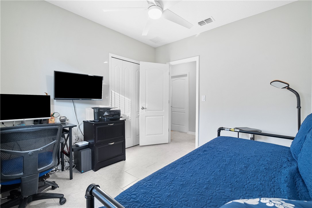 6187 Red Maple Manor Vero Beach, FL 32966 - Photo 20 of 31 a view of a workspace with furniture and a flat screen tv
