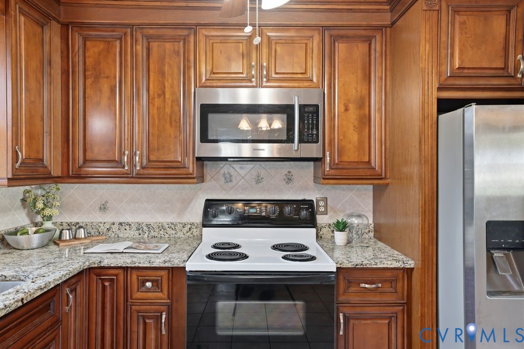 2701 Maury Road Petersburg, VA 23805 - Photo 13 of 41 a kitchen with granite countertop a stove top oven microwave and cabinets