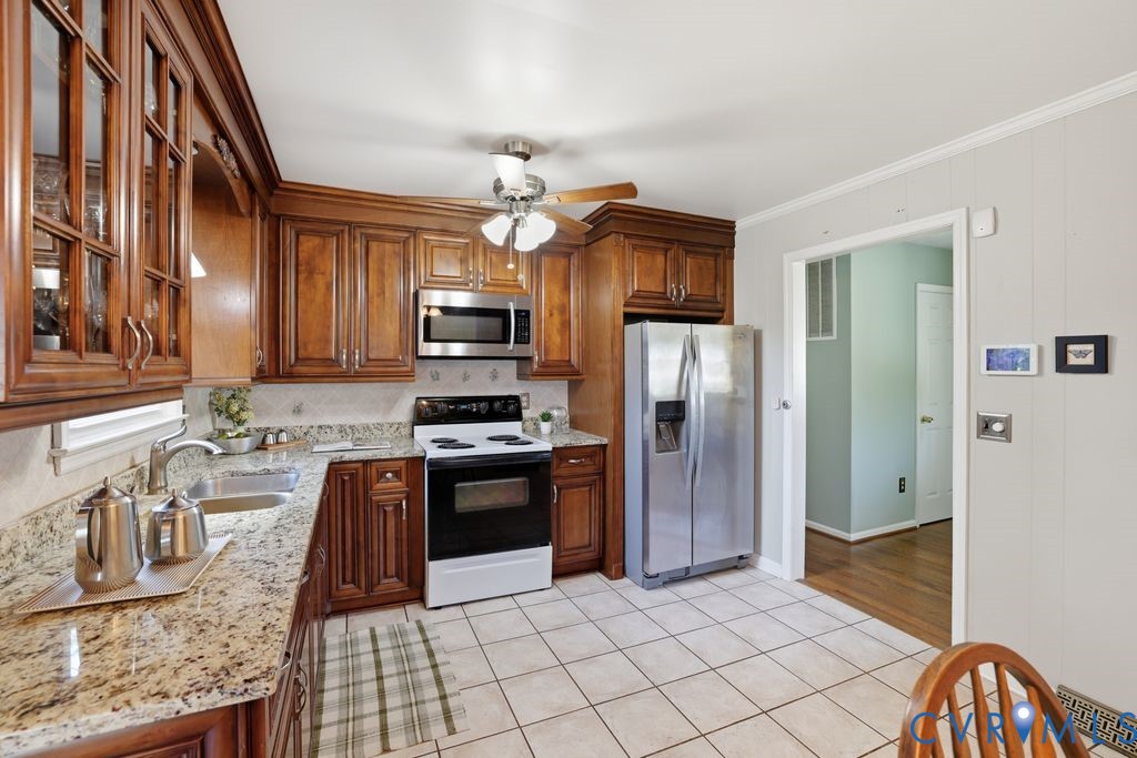 2701 Maury Road Petersburg, VA 23805 - Photo 14 of 41 a kitchen with stainless steel appliances granite countertop a refrigerator a stove top oven and sink
