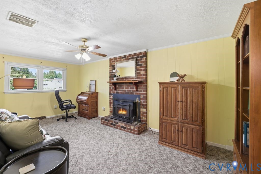 2701 Maury Road Petersburg, VA 23805 - Photo 18 of 41 a living room with furniture a fireplace and a flat screen tv