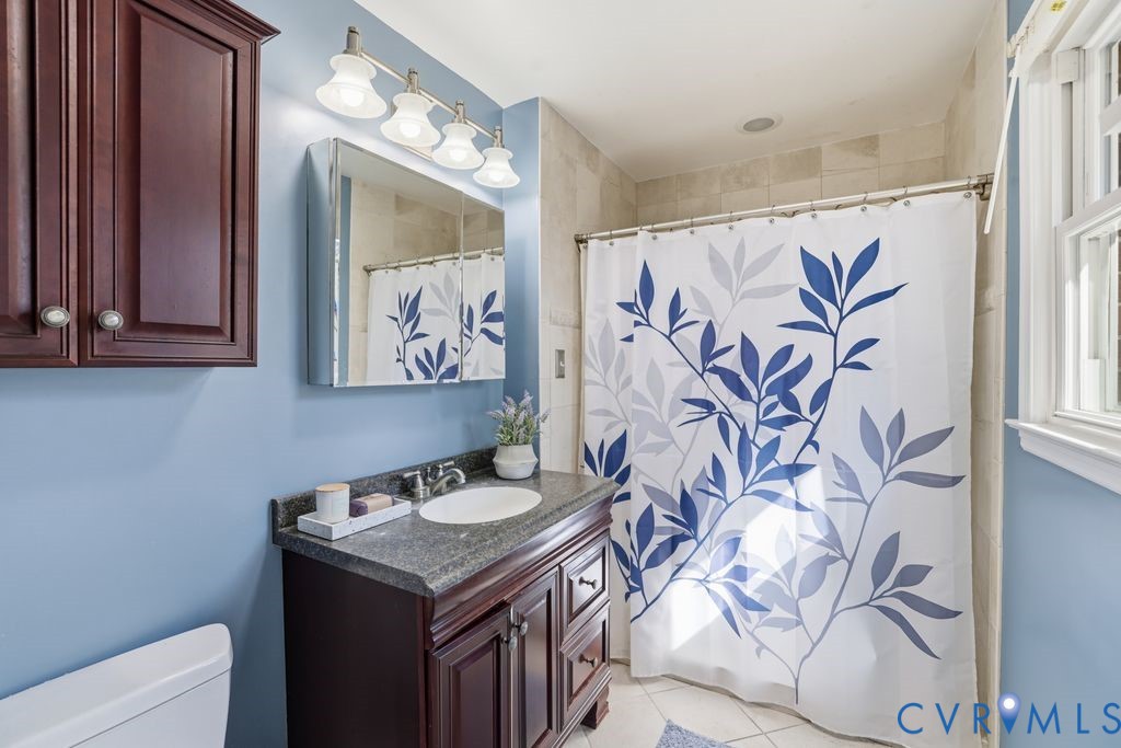 2701 Maury Road Petersburg, VA 23805 - Photo 28 of 41 a bathroom with a granite countertop sink a mirror and a shower