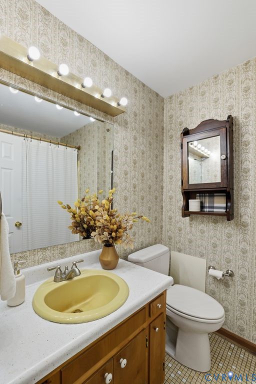 2701 Maury Road Petersburg, VA 23805 - Photo 31 of 41 a bathroom with a toilet sink and mirror
