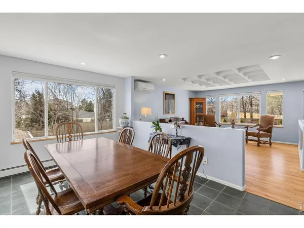 a dining room with furniture and wooden floor