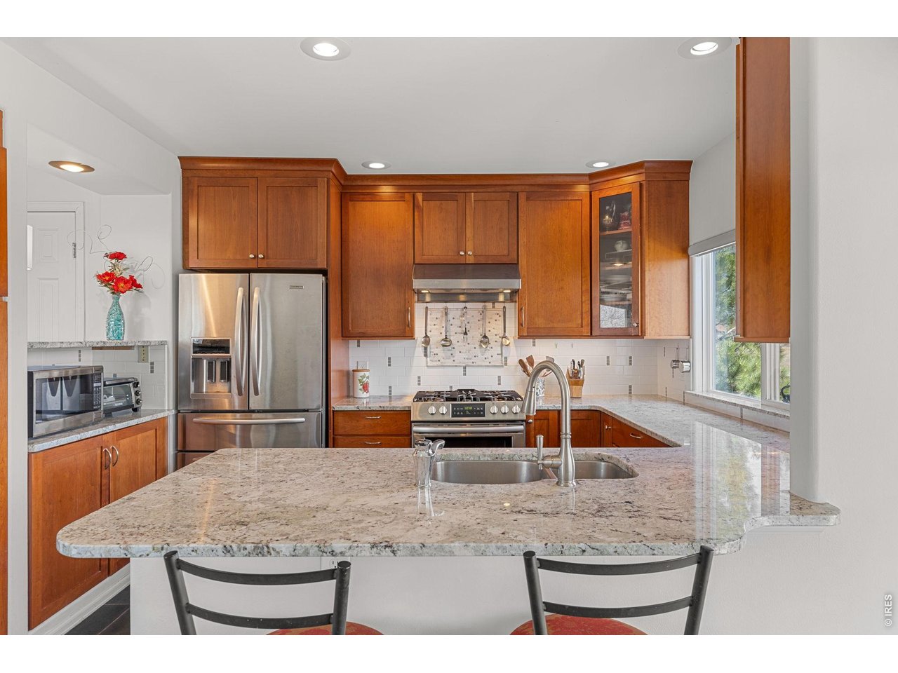 4490 Clay Street Boulder, CO 80301 - Photo 17 of 50 a kitchen with kitchen island granite countertop a sink and a counter top space