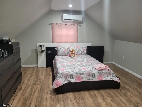 a bedroom with a bed and a night stand