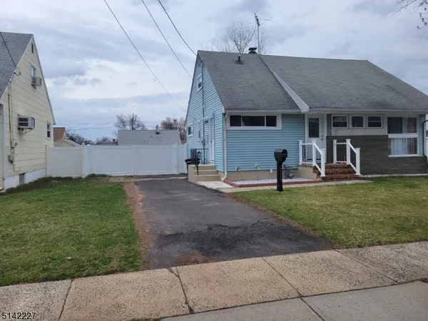 a view of a house with backyard and a patio