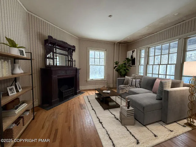 a view of empty room with wooden floor and fireplace