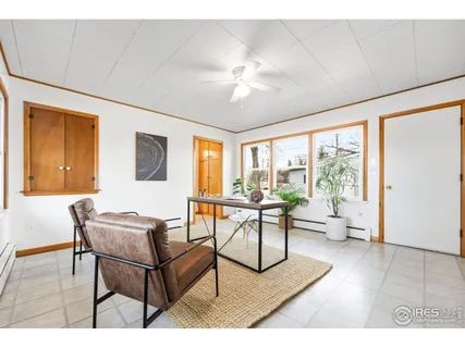a spacious bedroom with a bed and a chandelier