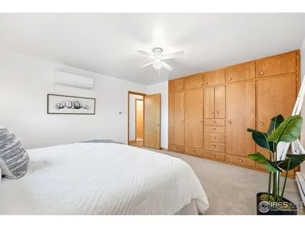 a bedroom with a bed and a painting on the wall