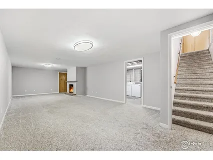 a view of empty room with fireplace