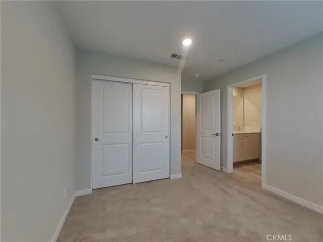 a view of an empty room and closet area