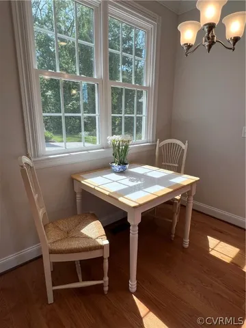 a view of a dining room with furniture window and wooden floor