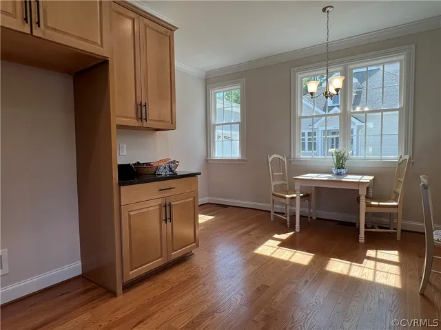 a kitchen with stainless steel appliances kitchen island hardwood floor sink stove and window