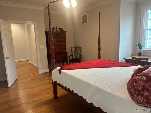 a bed sitting in a bedroom next to a window