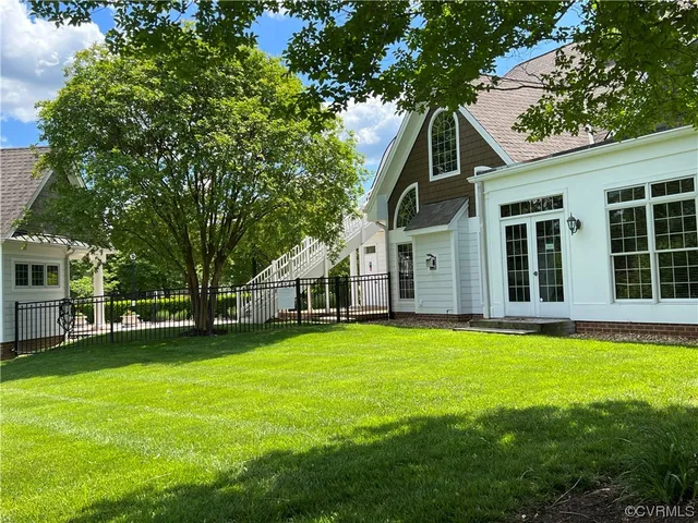 a front view of a house with a garden and trees