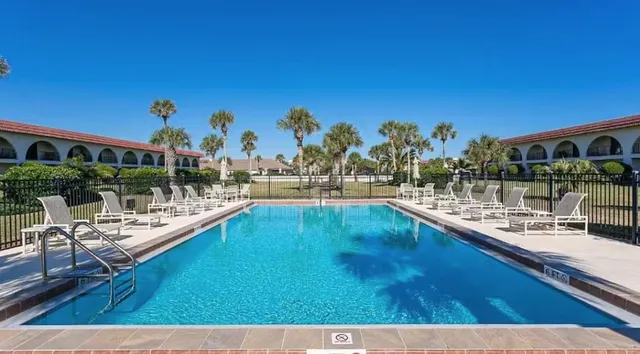 a view of a swimming pool with outdoor seating