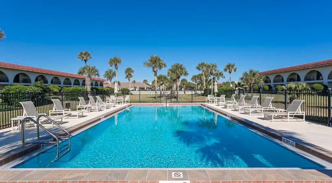 a view of a swimming pool with outdoor seating