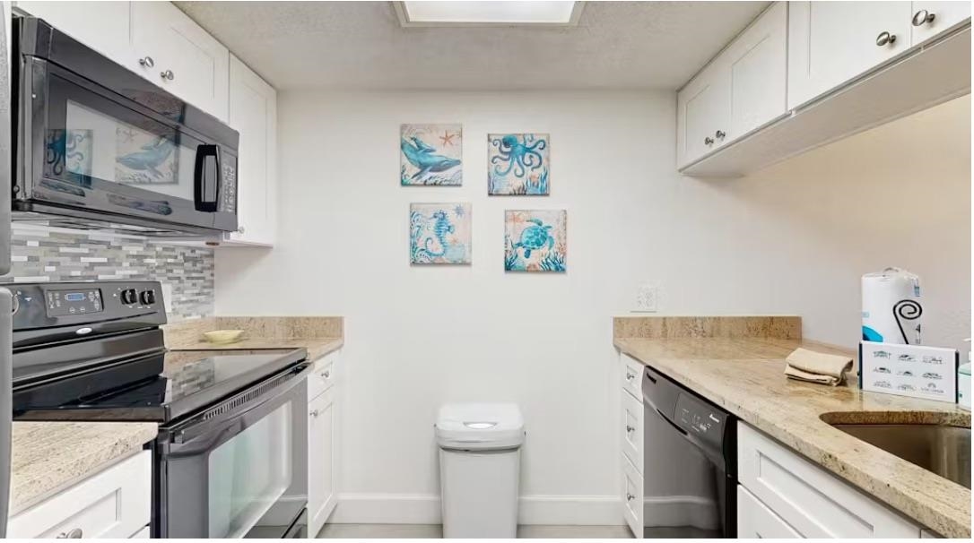 11 Dondanville Road, Unit 33 St. Augustine, FL 32080 - Photo 4 of 16 a kitchen with stainless steel appliances granite countertop a sink stove and cabinets