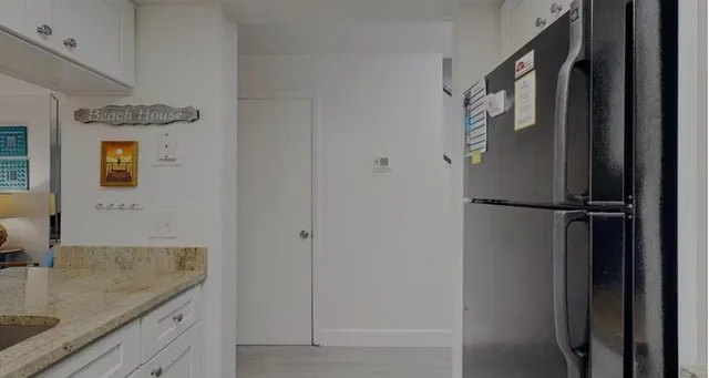 a bathroom with a granite countertop sink and shower