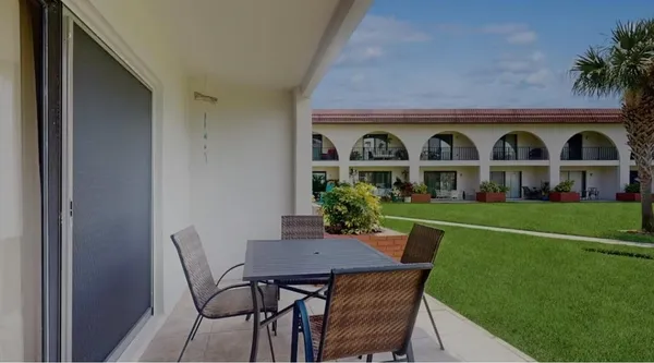 a front view of house with a garden and patio