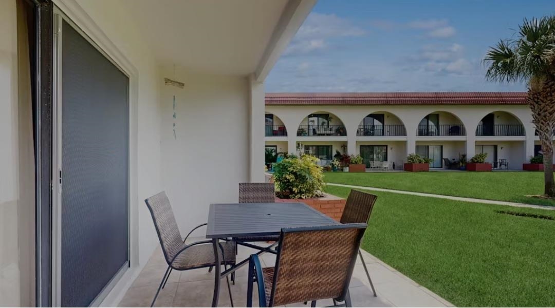 11 Dondanville Road, Unit 33 St. Augustine, FL 32080 - Photo 8 of 16 a front view of house with a garden and patio