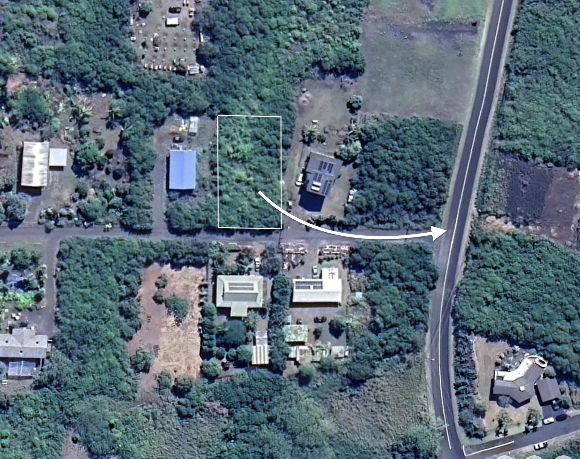 an aerial view of a house with backyard space and street view