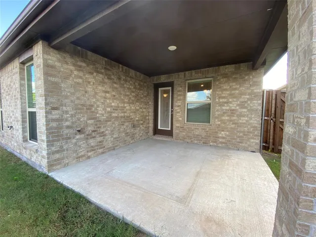 a view of a yard in front of a house with a large tree