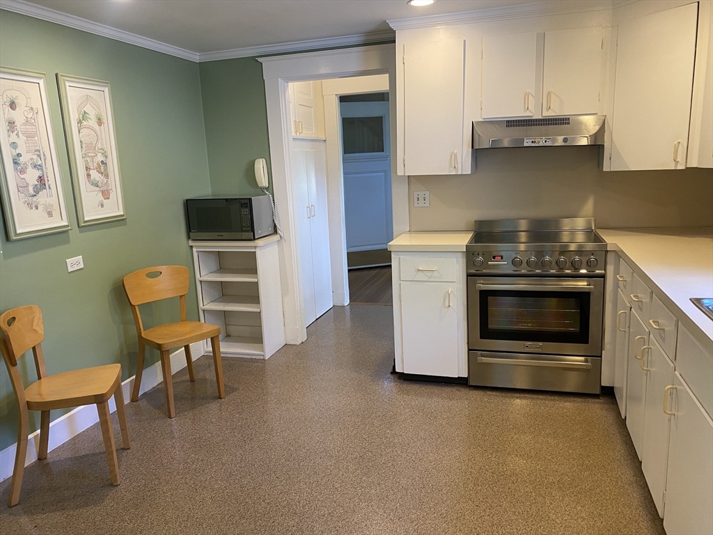 28 Fairview Road Needham, MA 02492 - Photo 18 of 26 a kitchen with stainless steel appliances granite countertop a stove and a refrigerator