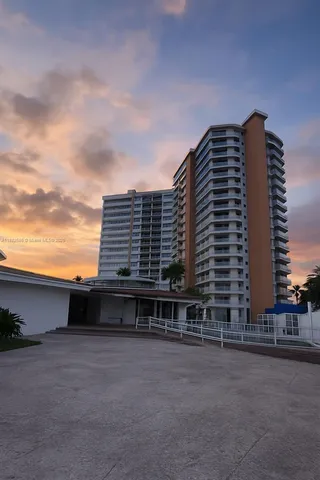 a view of a large building with a yard
