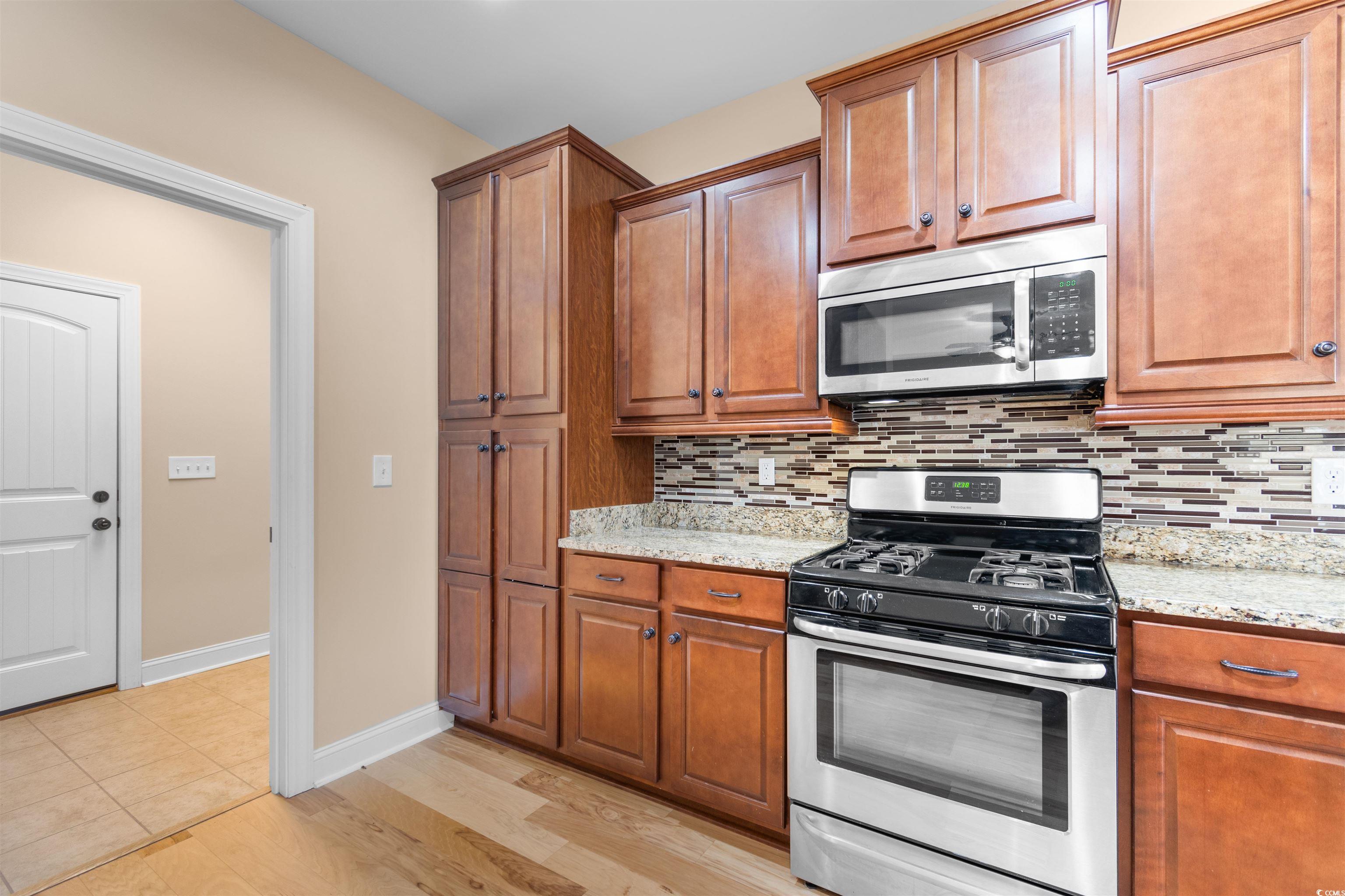373 Graytwig Circle Murrells Inlet, SC 29576 - Photo 13 of 39 Kitchen featuring decorative backsplash, light sto
