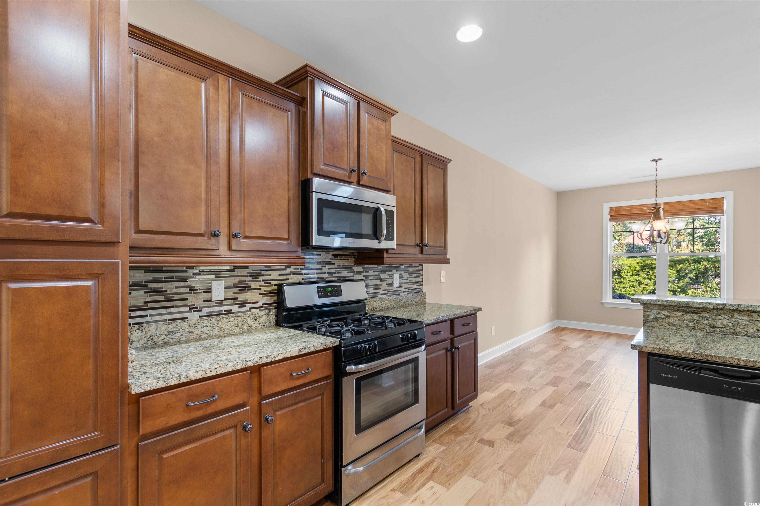 373 Graytwig Circle Murrells Inlet, SC 29576 - Photo 10 of 39 Kitchen with light stone countertops, light hardwo
