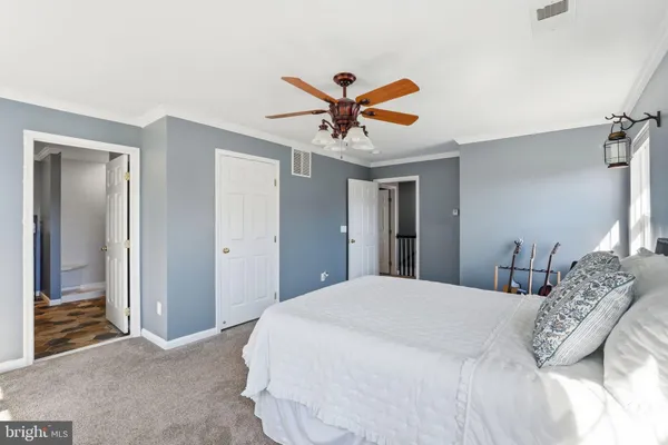 a bedroom with a bed and a couch