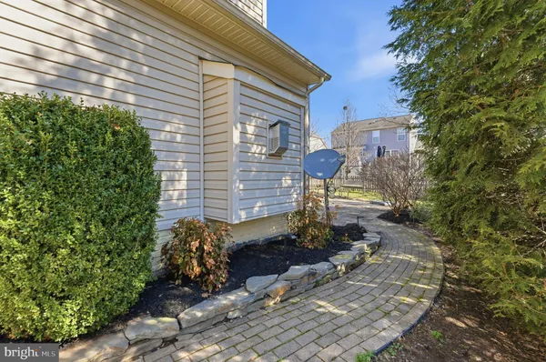 a front view of a house with a garden and yard